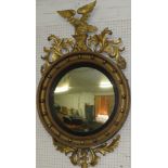 Regency convex circular wall mirror with gilt ball frame, ebonised slip, with eagle and acanthus