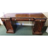 Early 19th century breakfront mahogany serving sideboard on pedestals, the top with tongue grooved