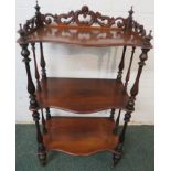 19th century mahogany three-tier serpentine front what-not, supported on slender baluster turned