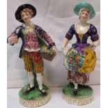 Pair of Derby style porcelain figures of flower sellers, a lady with flowers in her apron and a