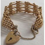 9 carat gold gate-link bracelet with heart shaped lock, 14.1g, in a Percy Davis and Son blue