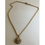 Circular foliate pendant set with thirty-three seed pearls, on a 9 carat gold rope chain stamped 9C,