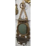 Gilt wood wall bracket with oval mirror and a shelf above and below, carved acanthus and swags and a