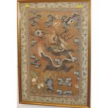 A Chinese silk embroidered panel with dragon and flaming pearl, bat and fish amongst stylized