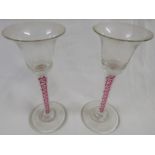 A pair of reproduction pink and white multiple helix stemmed cordial trumpet glasses, height 16cm