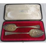 A matched pair of Georgian silver berry spoons in a more recent fitted case, the first bearing marks