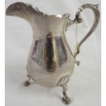 Fisher Sterling white metal milk jug with barbed rim, double scroll handle, on three scallop and