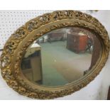 Bevelled oval wall mirror in a heavy carved gilt wood acanthus frame, (glass height 56.5cm width