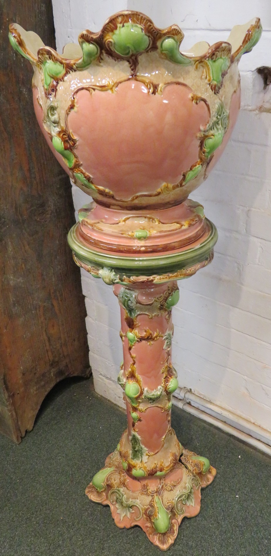 Victorian majolica jardiniere on stand, pink ground with green and brown oak foliage, requires