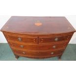 A Regency period bow-fronted chest of two short over two long drawers in rosewood and mahogany