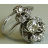 18 carat white gold diamond cluster ring set with seven stones, the central cushion cut stone (