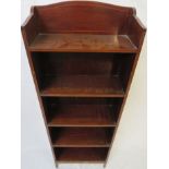 A narrow mahogany veneer open bookcase of five shelves with ebony geometric inlay to the front