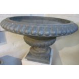 Zinc garden urn with bulbous column and reeded borders, standing on a square foot, height 53cm,