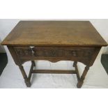 Oak side table with single drawer, shaped apron and dowel joints, the drawer front carved with