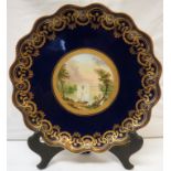 Coalport style cabinet plate, dark blue enamel with a gilt margin of scrolled swags, the central