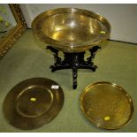 BEATEN AND ENGRAVED BRASS BOWL ON WOODEN STAND, TOGETHER WITH TWO BRASS TRAYS