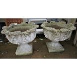 PAIR OF COMPOSITE STONE GARDEN URNS