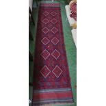 HAND KNOTTED WOVEN RED GROUND FLOOR RUNNER WITH TASSELLED ENDS, 264CM X 60CM