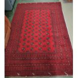 AFGHAN HAND-KNOTTED RED GROUND PATTERNED WOOL RUG, (237CM X 162CM) (COPY OF RECEIPT FROM MICHAEL