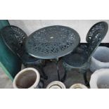 GREEN PAINTED CAST METAL CIRCULAR GARDEN TABLE AND A PAIR OF MATCHING CHAIRS WITH FOLIATE DESIGN