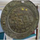 CIRCULAR EMBOSSED METAL WALL HANGING DEPICTING A TAVERN SCENE