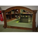 ARCHED TOP OVERMANTLE MIRROR IN OAK FRAME WITH IONIC COLUMNS TO EITHER SIDE