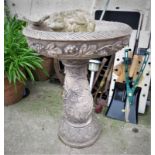 COMPOSITE STONE TWO PART BIRDBATH WITH GRAPE VINE DECORATION AND PERCHED BIRD, TOGETHER WITH