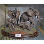 COUNTRY ARTISTS RESIN GROUP OF FOUR ELEPHANTS, CA521 'VOICE OF AFRICA', ON OVAL WOODEN BASE