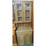 STRIPPED LIGHT WOOD NARROW DRESSER, THE TOP WITH TWO LEADED GLAZED DOORS ENCLOSING TWO SHELVES,