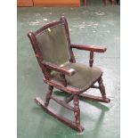 STAINED OAK FRAMED CHILD'S ROCKING CHAIR WITH GREEN VELVET SEAT AND BACK PADS