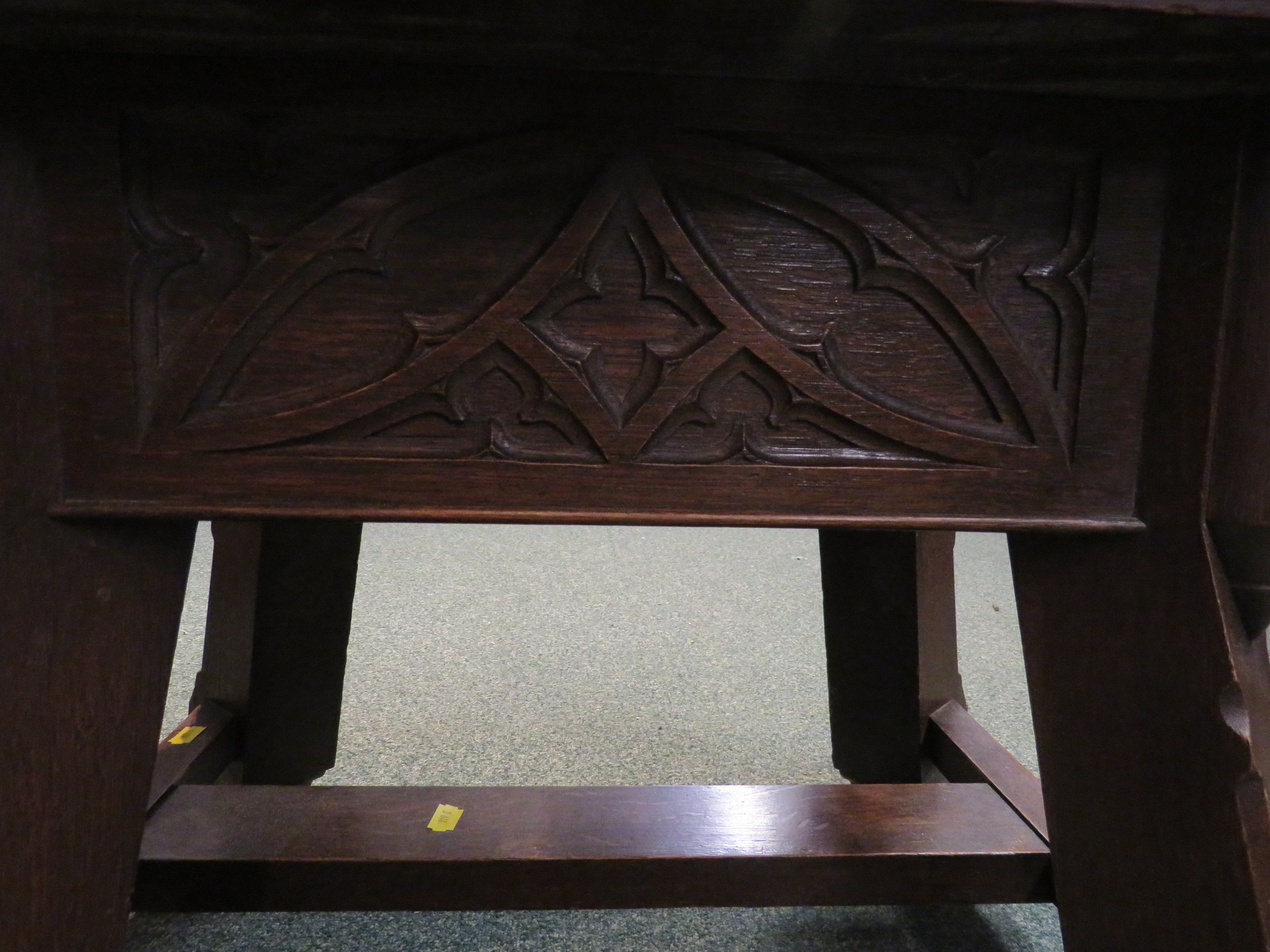 Gothic style oak stool with foliate carving to the frieze and stout stretchered out swept legs, - Image 3 of 5