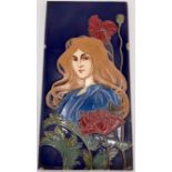 An Art Nouveau ceramic tile by Carl Sigmund Luber, depicting head and shoulders of woman in blue