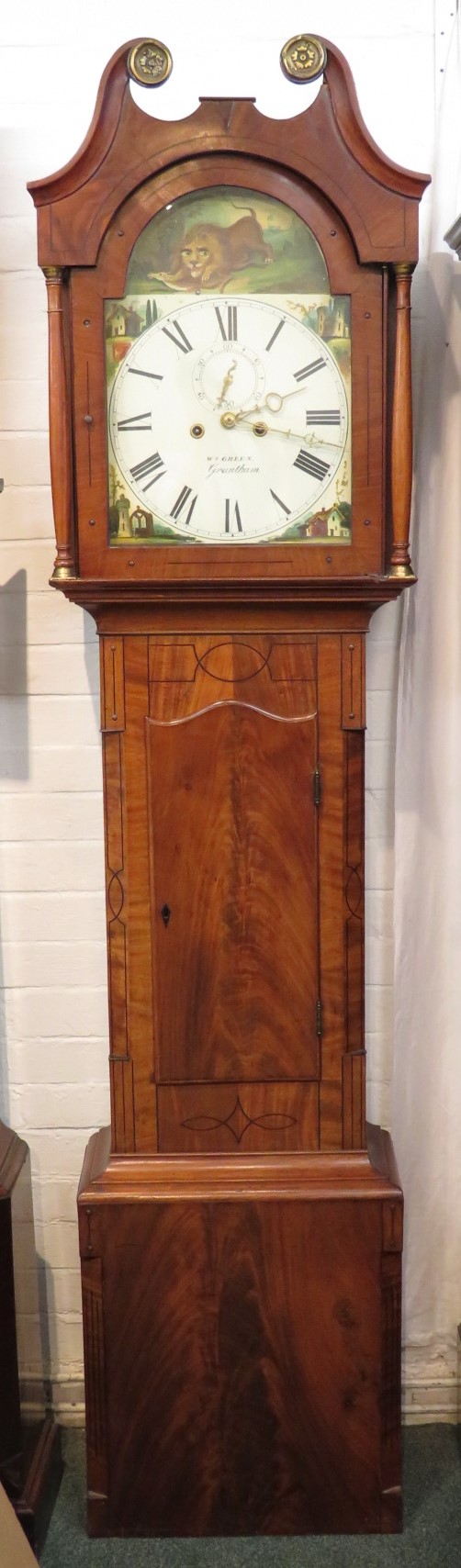 A 19th century eight-day long case clock with automaton dial, the mahogany case with small