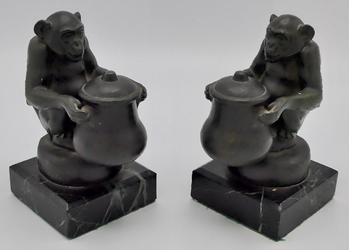 Max Le Verrier (1891-1973) - a pair of bronze bookends modelled as seated chimpanzees each holding a