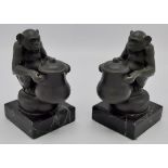 Max Le Verrier (1891-1973) - a pair of bronze bookends modelled as seated chimpanzees each holding a