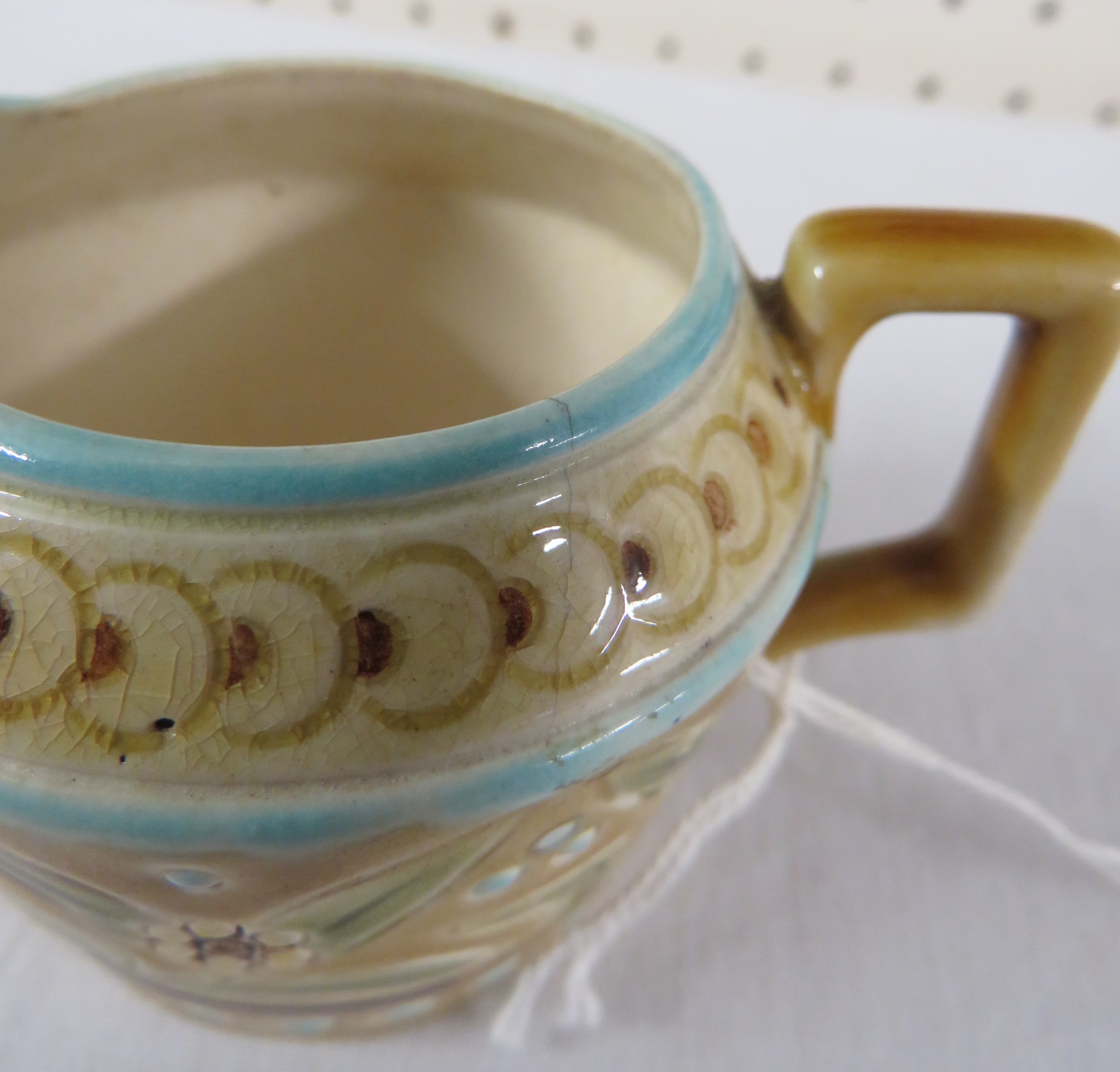 A small Linthorpe Pottery milk jug, pale treacle glaze with blue dots and lines and a band of - Image 4 of 6