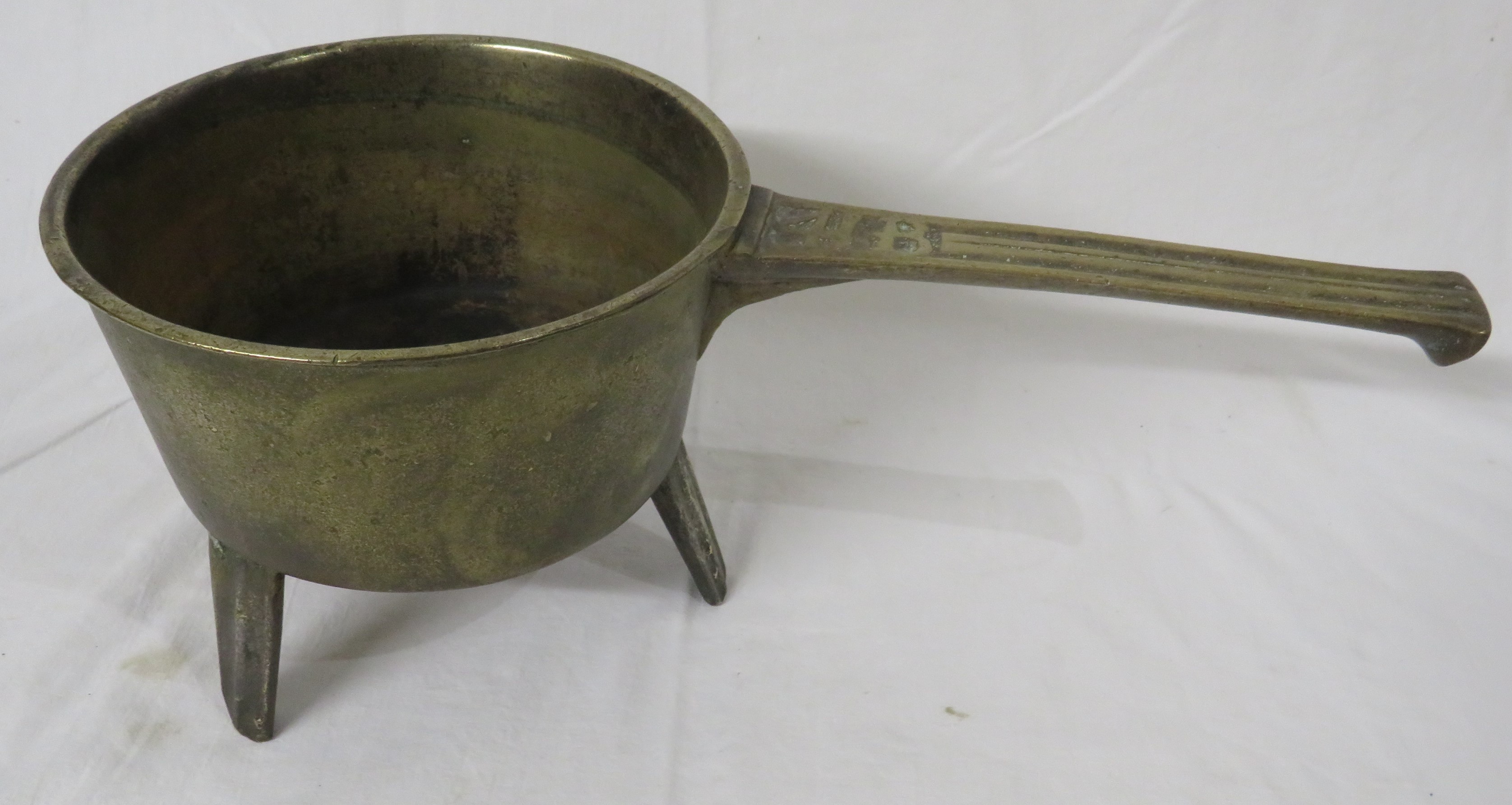 Brass skillet raised on three legs, handle marked 41B, length 45.5cm, height 17.5cm