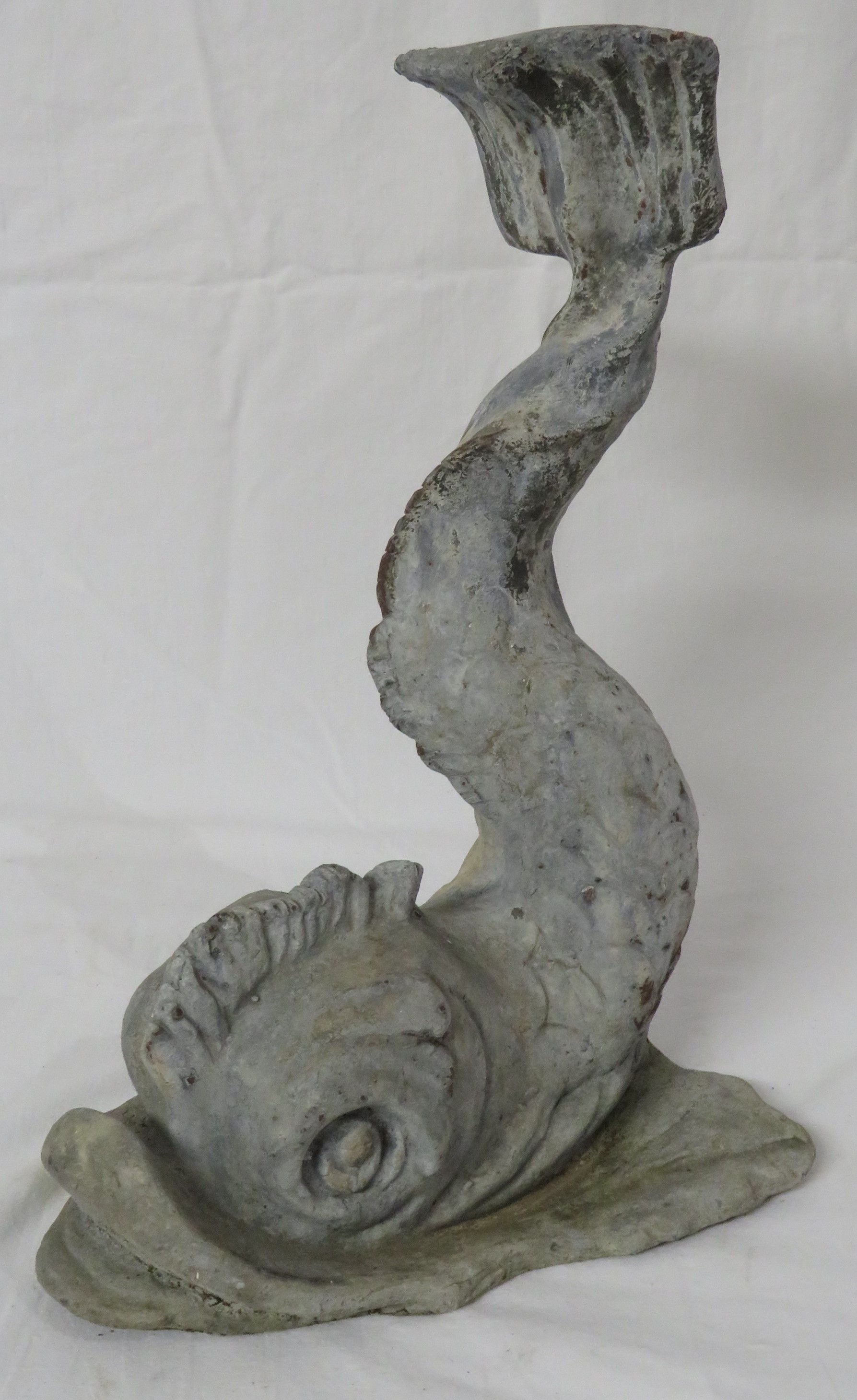 Cast lead garden ornament modelled as a scaled fish or dolphin with raised tail, height 34.5cm