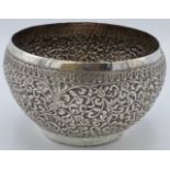 Far Eastern white metal bowl with repousse scrolled foliage between patterned borders, the bottom of