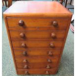 A 19th century mahogany collector's table-top chest of seven shallow drawers, original turned knop