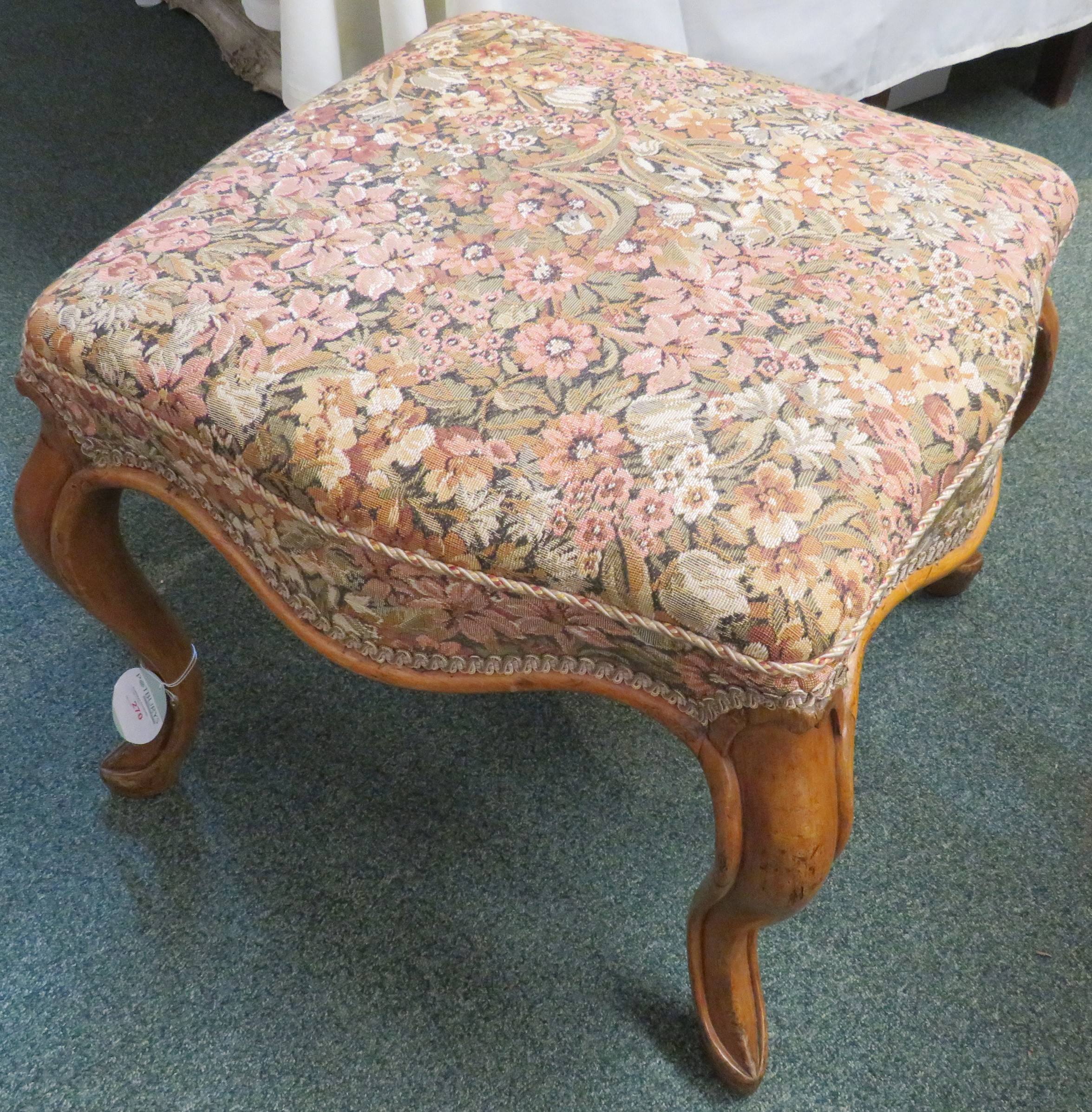 A square low stool with horsehair stuffed seat and pale foliate upholstery, walnut frame with wavy