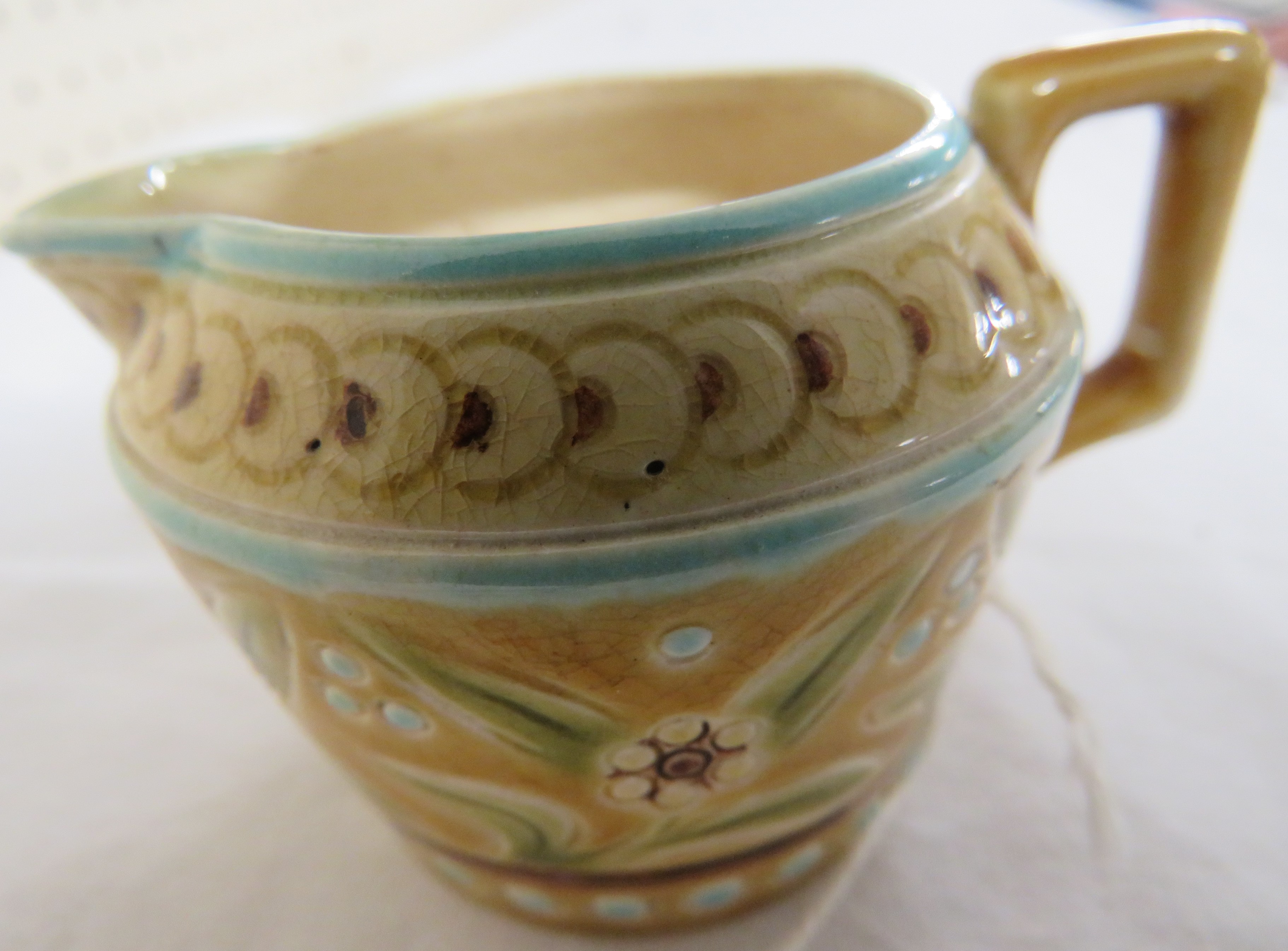 A small Linthorpe Pottery milk jug, pale treacle glaze with blue dots and lines and a band of - Image 6 of 6