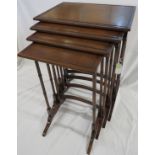 An elegant nest of four mahogany tables, raised on slender gun barrel supports, the back legs with