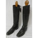Pair of black leather riding boots with wooden trees, leather insoles marked Moss Bros Covent