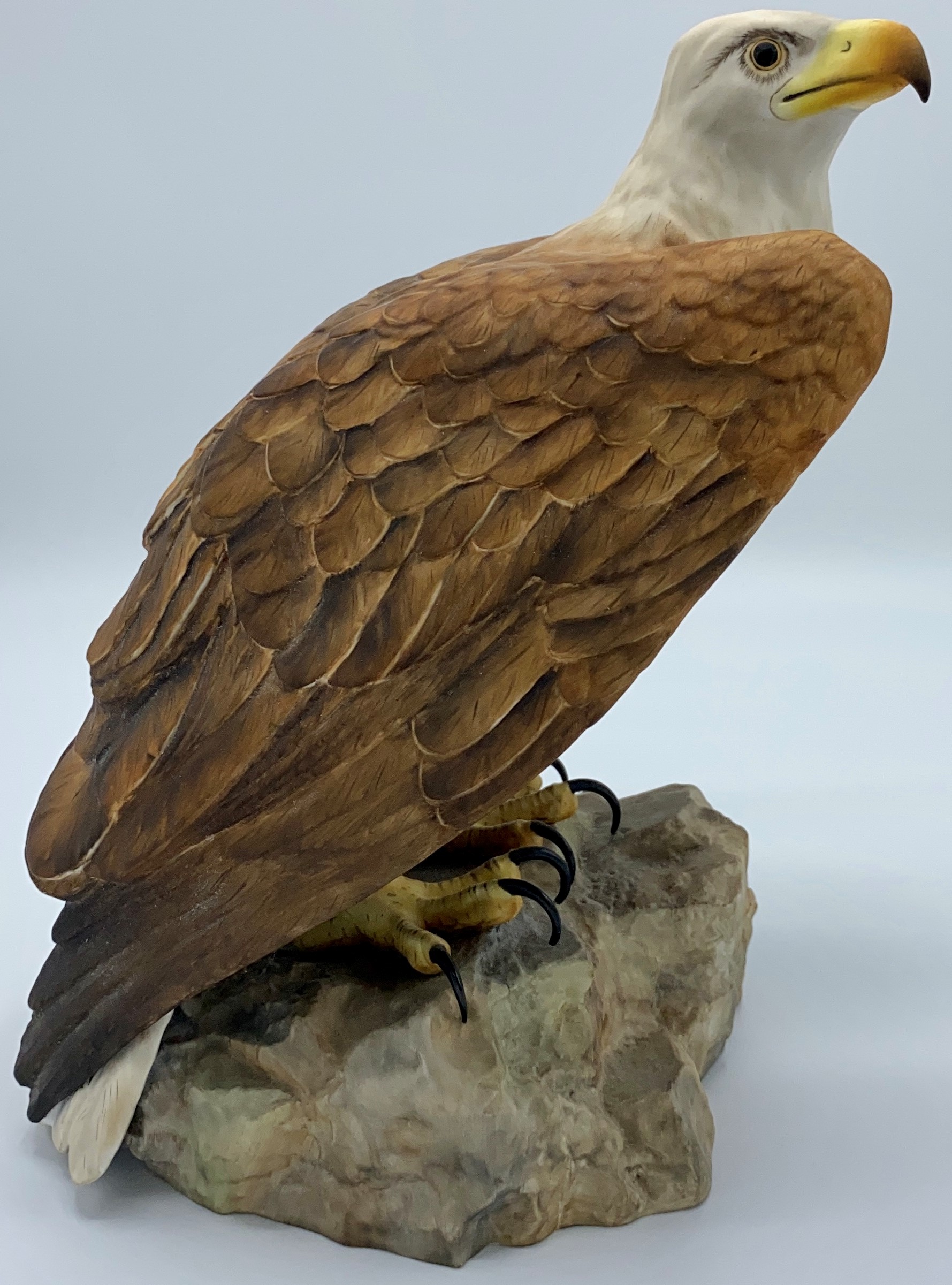Royal Crown Derby porcelain figure of bald eagle, modelled standing on rocky outcrop, red factory