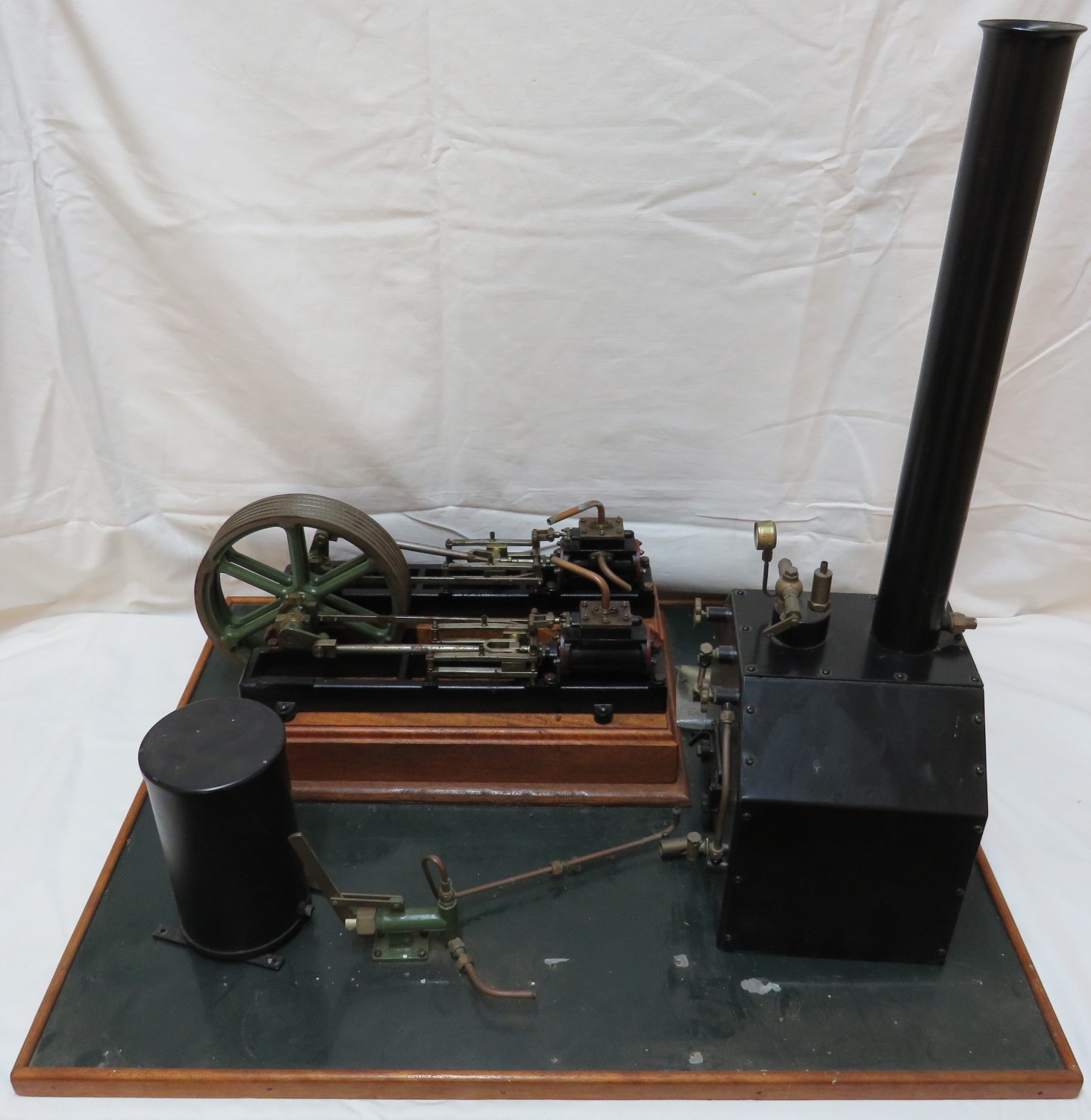 A model of a 'Victoria' double cylinder steam engine, diameter of flywheel about 18cm, mounted on