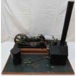 A model of a 'Victoria' double cylinder steam engine, diameter of flywheel about 18cm, mounted on