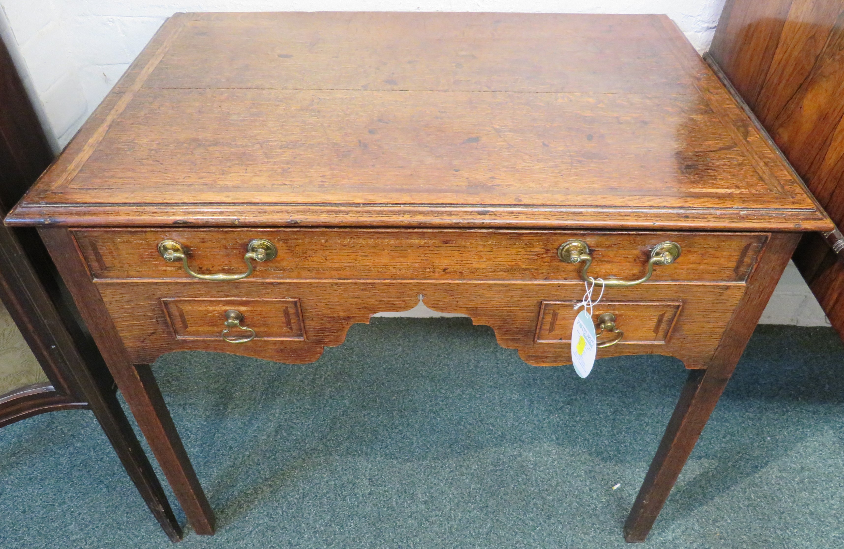 19th century banded oak desk with one long drawer over two short drawers either side of a wavy