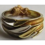 18 carat two-tone imported gold ring with cross-over stylized leaf strands, the shank with import