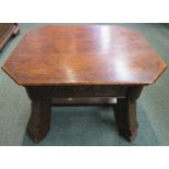 Gothic style oak stool with foliate carving to the frieze and stout stretchered out swept legs,